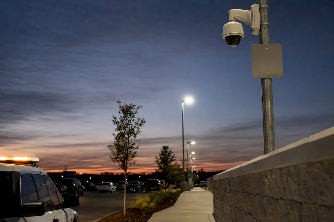Parking lot security camera and patrol vehicle