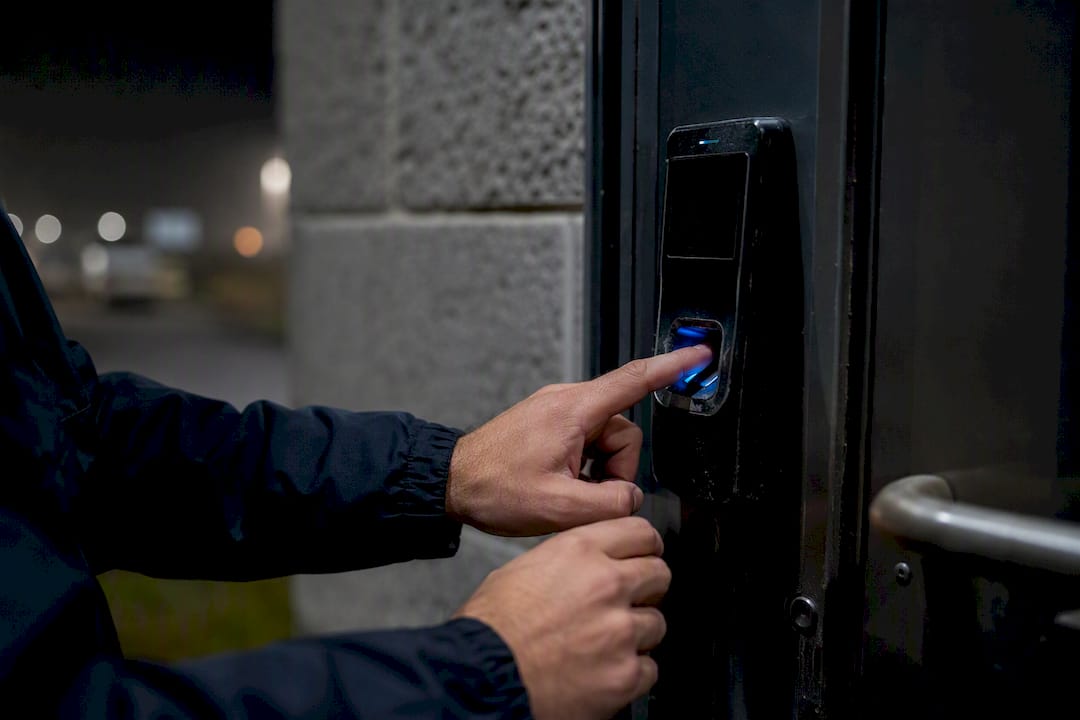 Security professional inspecting access control panel