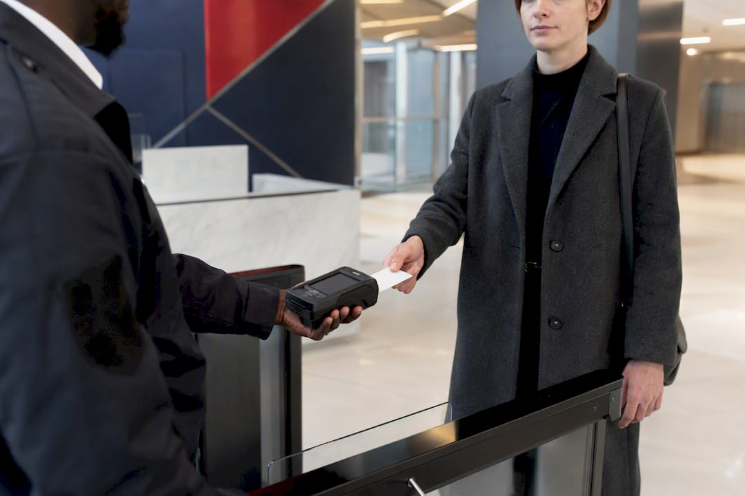 Guard scanning visitor badge at office entrance